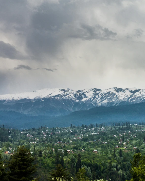 the view of a snow covered mountain range from an overlook point