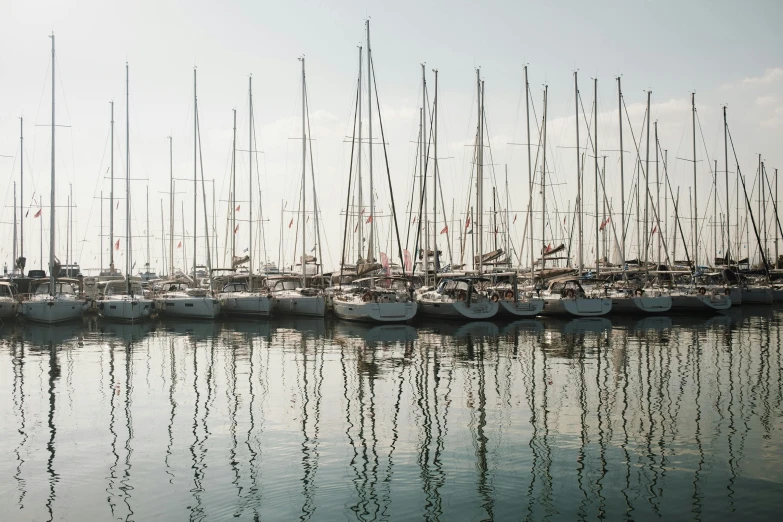 several boats are docked with each other in the water