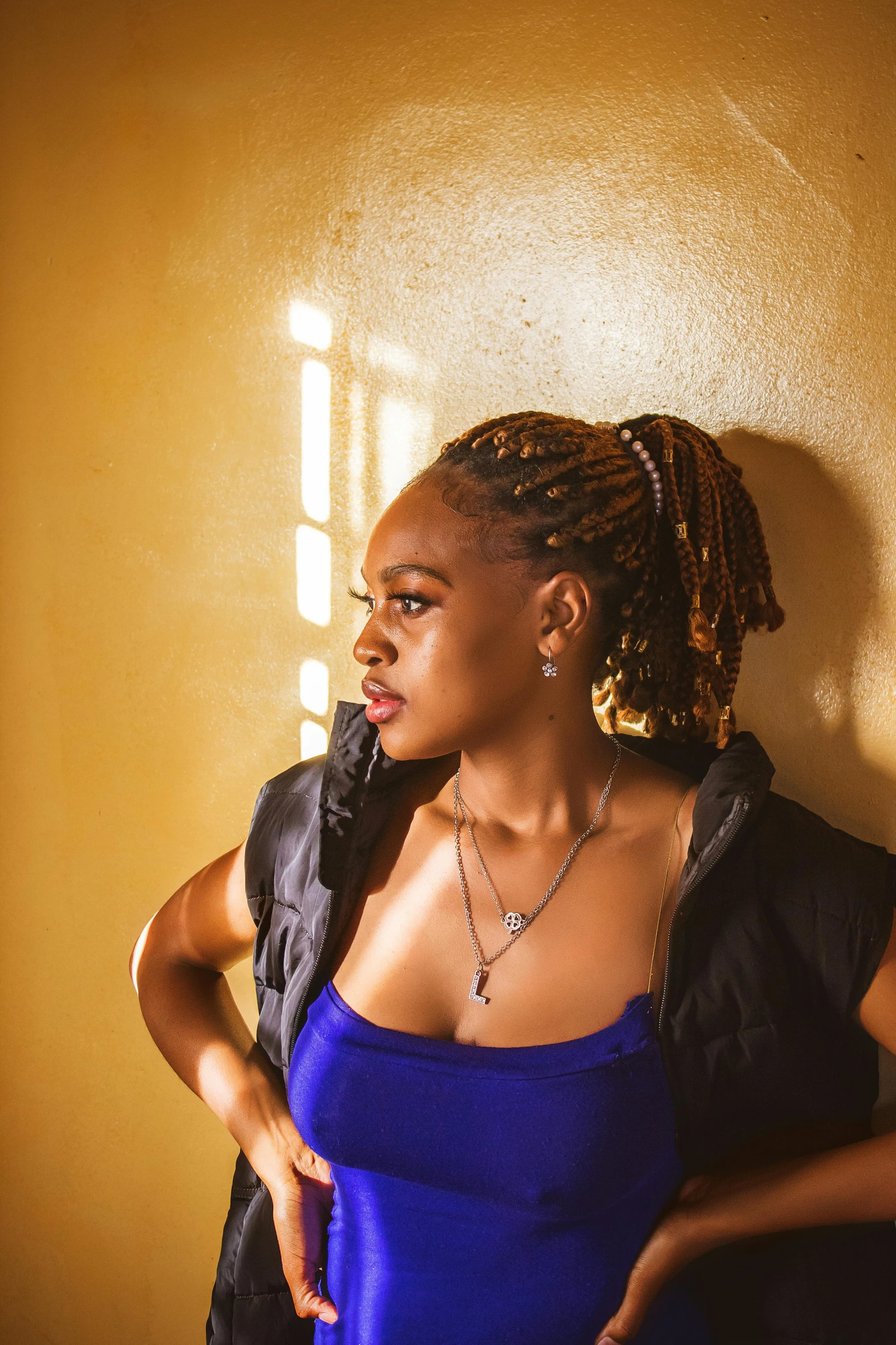 a woman posing with her arms behind her back