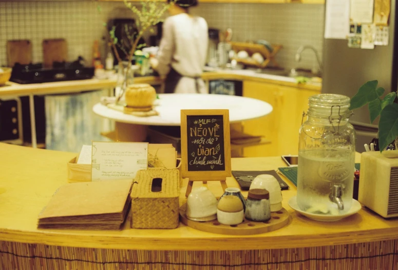 a kitchen with two people standing in the background