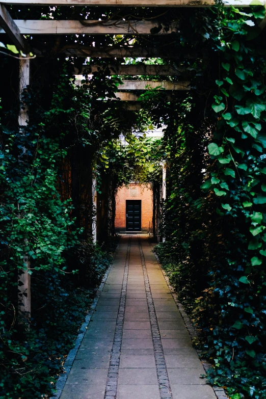 an open walkway leads to a building with a tiled roof