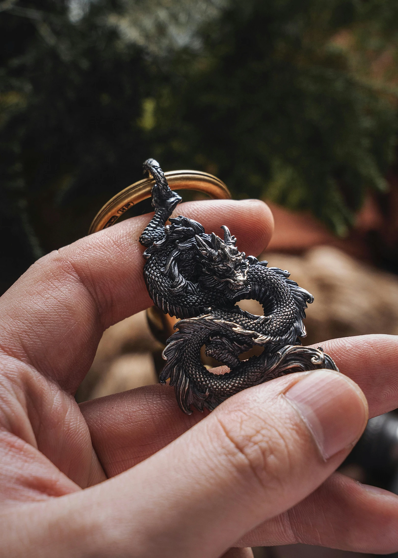 someone holds up two rings that have been designed to look like animals