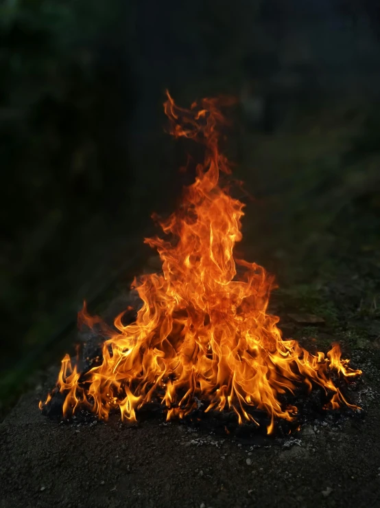 a large flame with a dark background