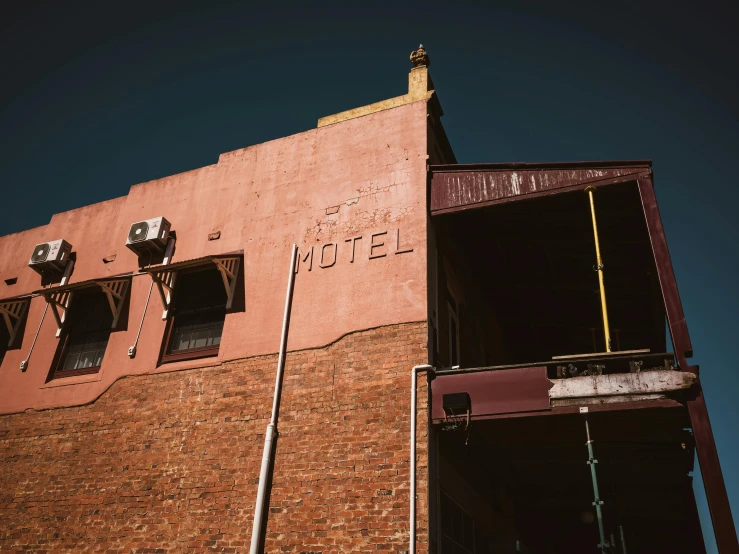 the side of an old building with broken windows