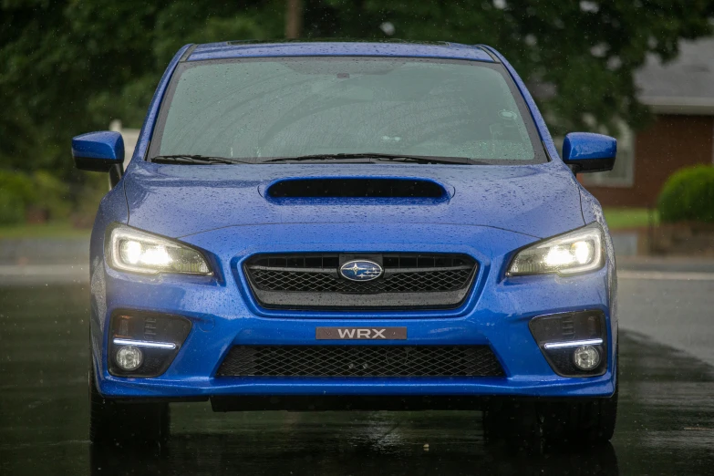 the front end of a blue subarunt on the street