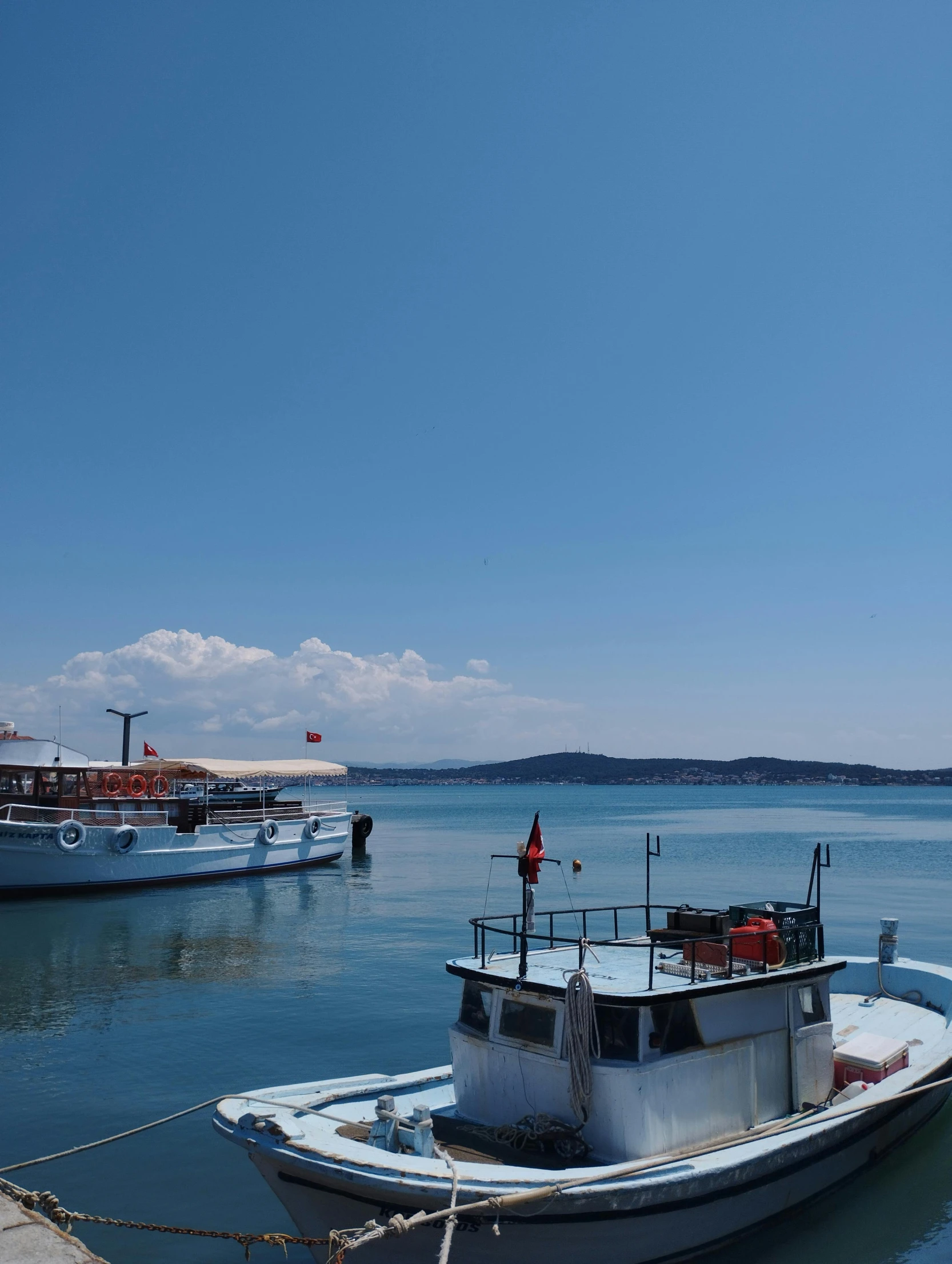 the small boat is tied to the dock