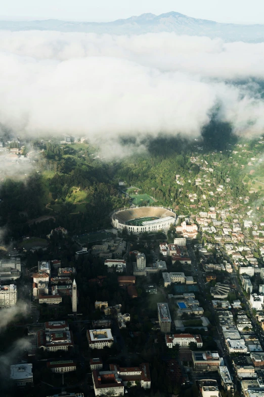 a city with lots of clouds and trees on it