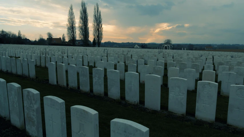 large military headstones standing in rows in a grassy field