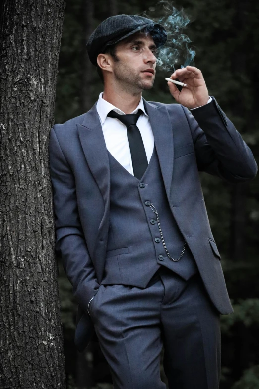 a man in a suit is smoking a cigarette