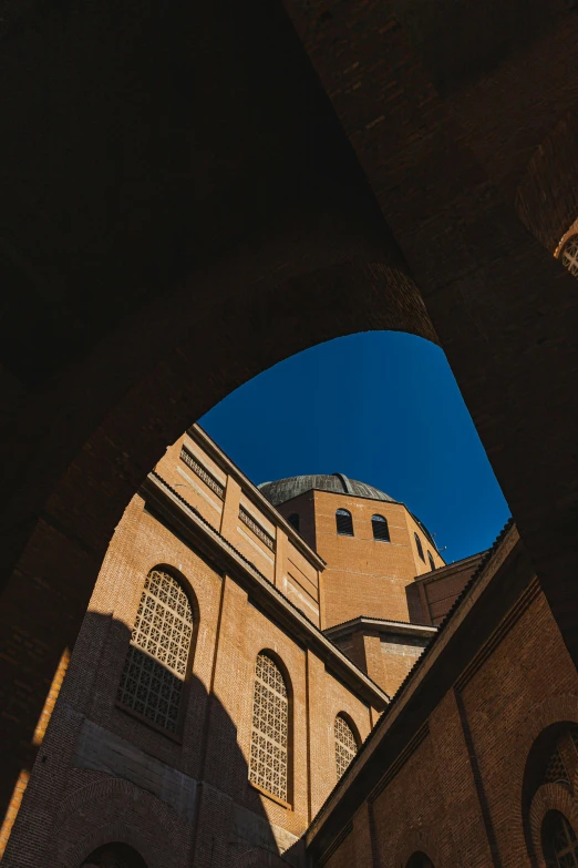 an arch and building with a view of the sky