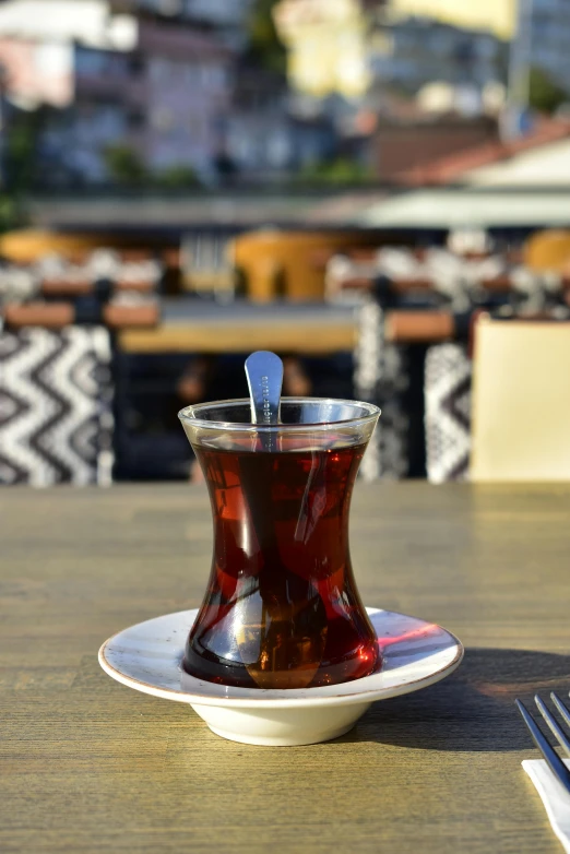 a cup filled with a beverage on top of a plate