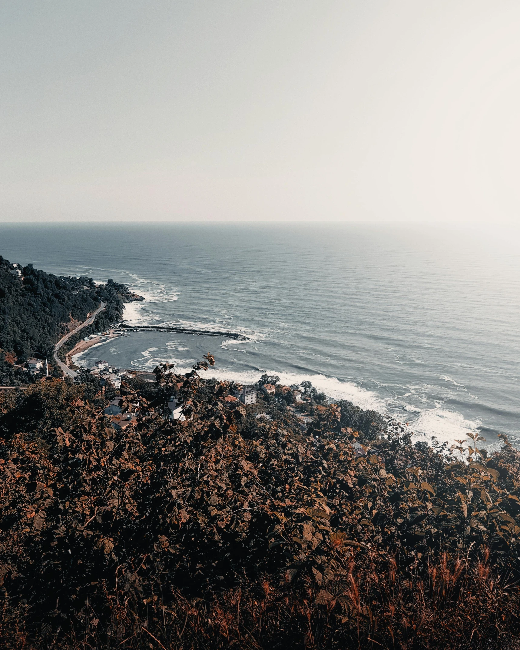 a rocky beach sitting along the ocean with a body of water near the shore