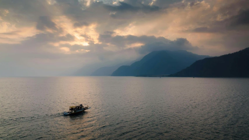 a boat is in the water during a cloudy day