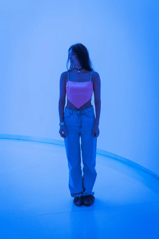 a woman is standing on a floor in a blue room