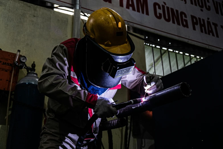 a person welding and wearing a helmet that is reflective