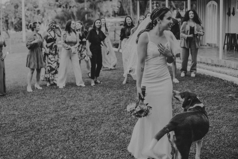 a bride and her dog before the ceremony at their home