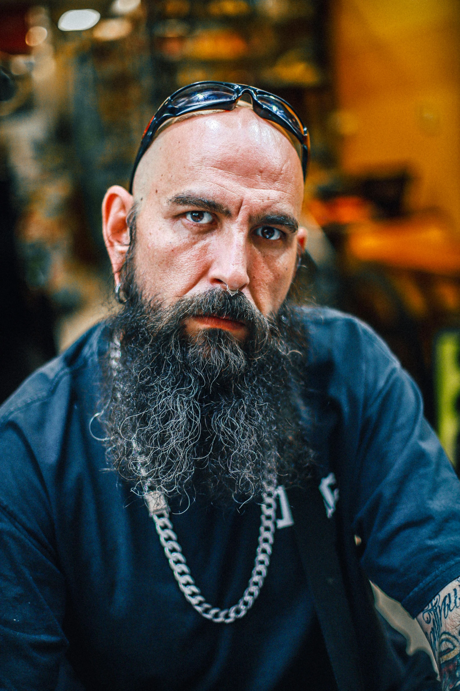 a man with a beard and chain sitting