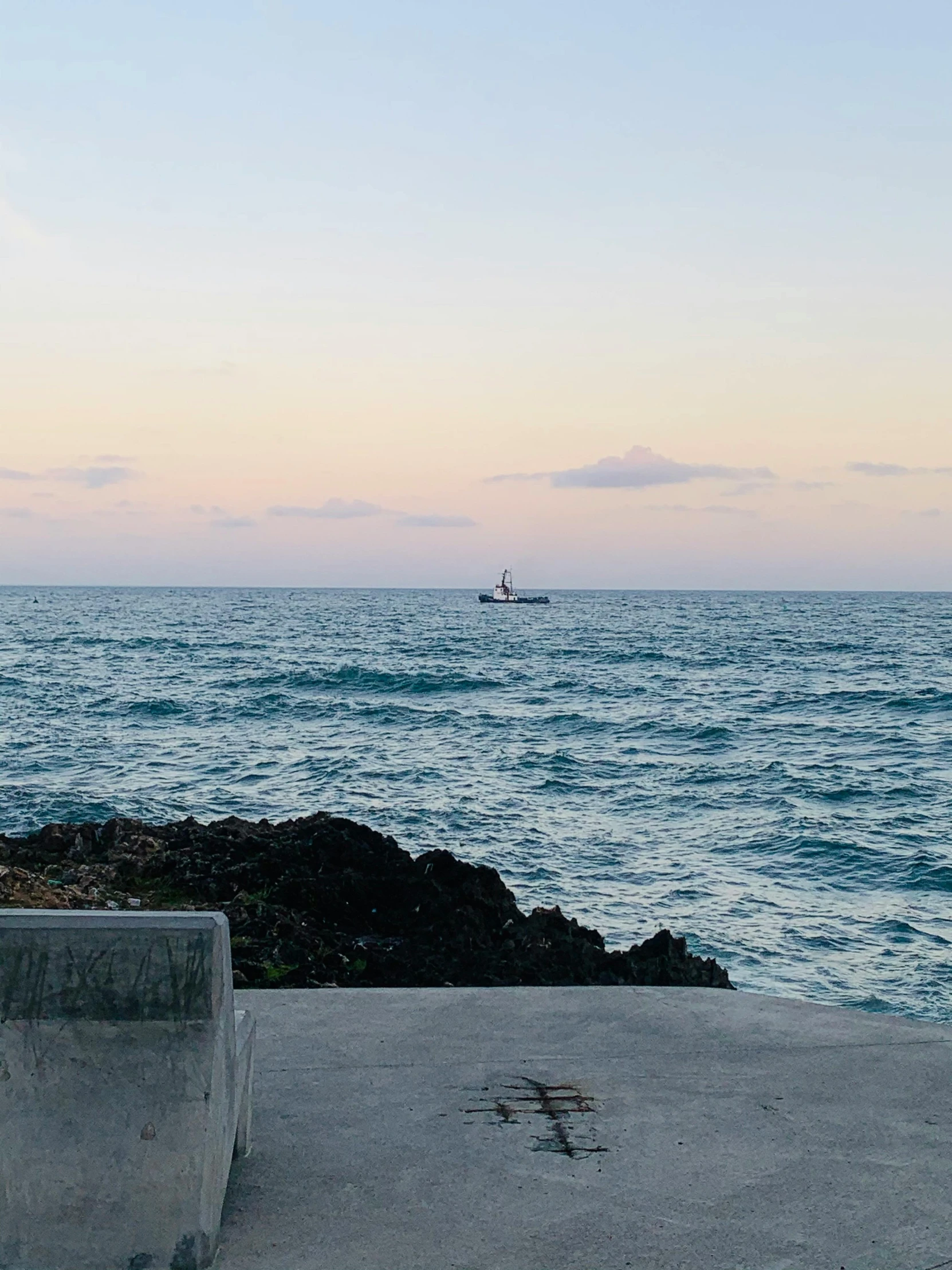 an ocean view with water, and a boat