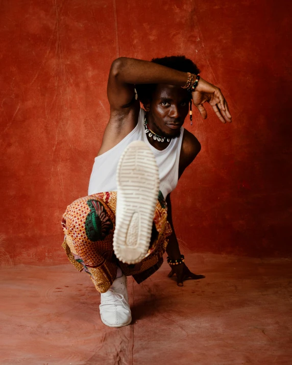 a woman poses in her hip hop while wearing all white and a brown hat