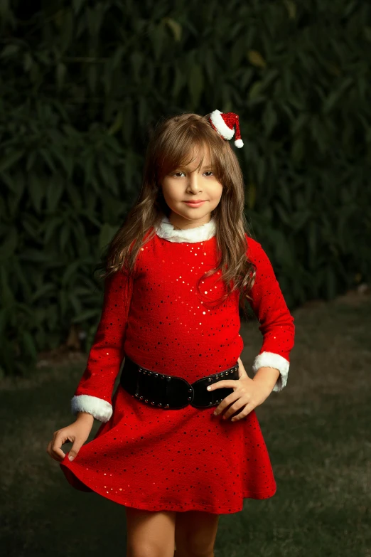 a little girl dressed in a christmas outfit