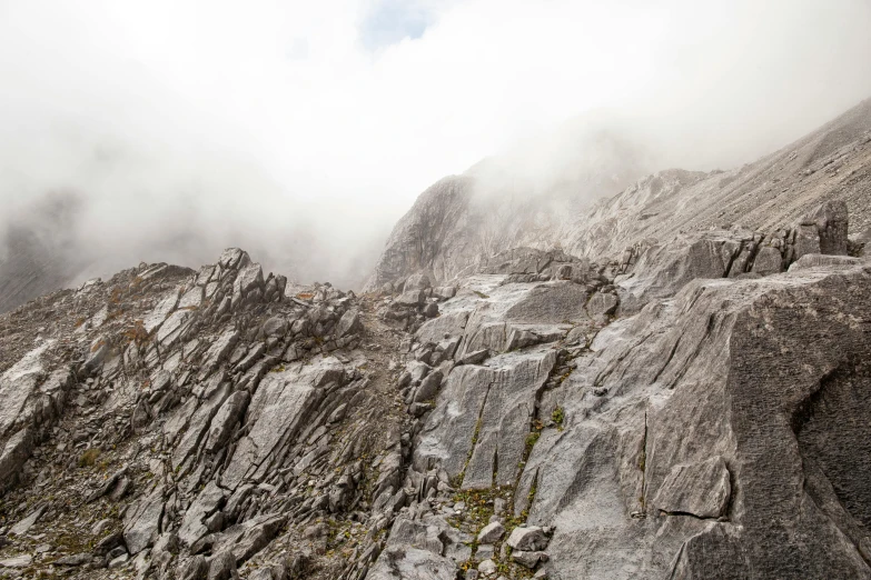 fog covering mountains with a cloud in the sky