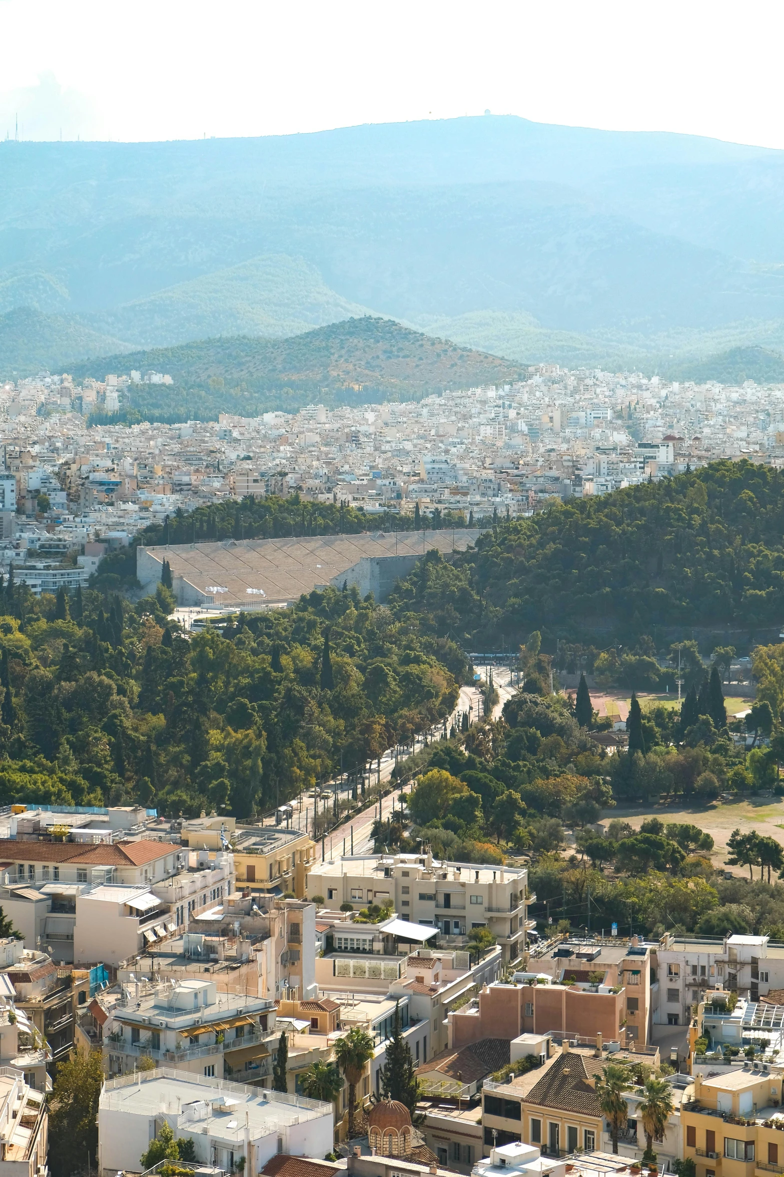 a bird - eye view of an aerial view of the city and mountains