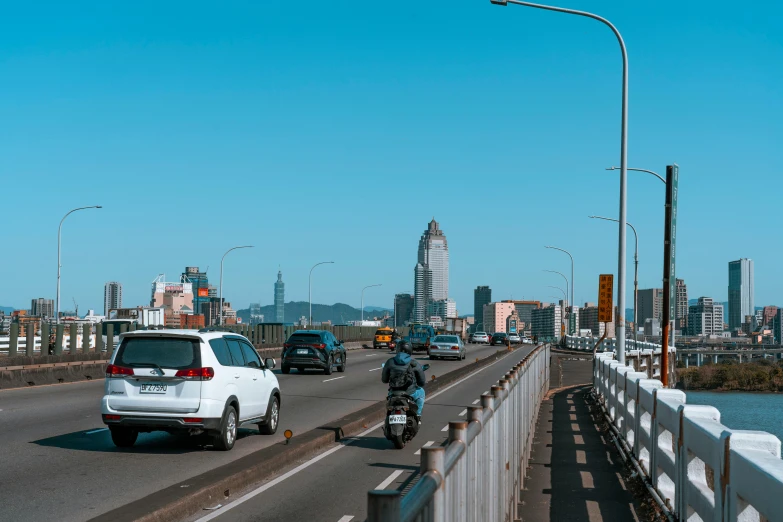 cars, motorcycles and trucks travel on a road