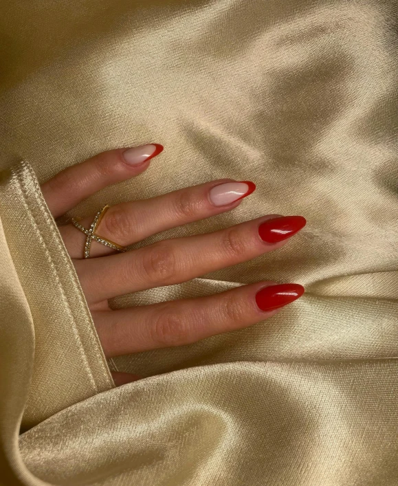 woman with red nails and long gold coat with jewelry