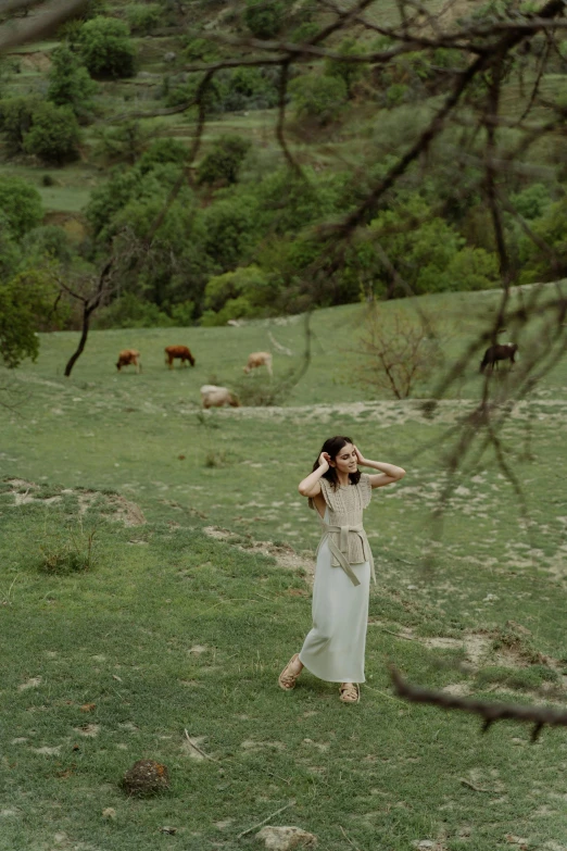 woman on a farm with cattle grazing in the background