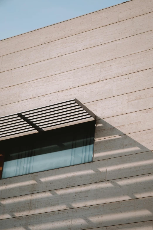 sunlight streams through the window onto the side of a house