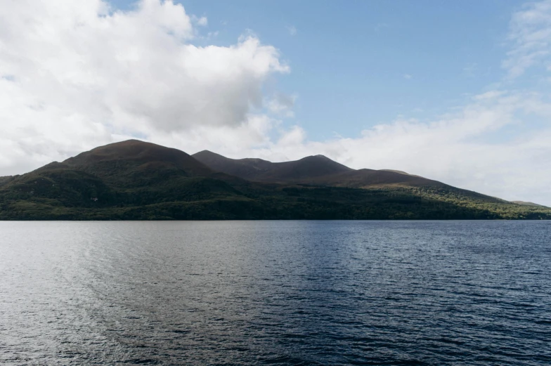 the mountains are visible above the water in the lake