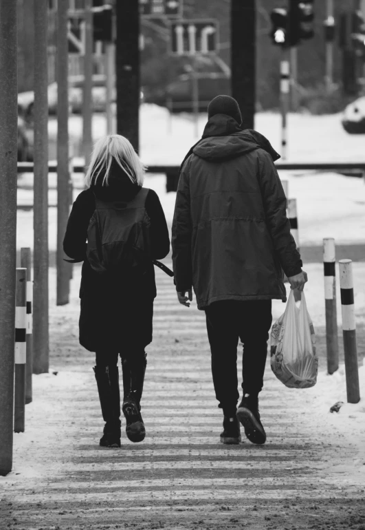 two people are walking down the street together