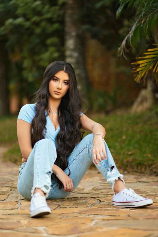 a beautiful young woman with long dark hair posing for a portrait