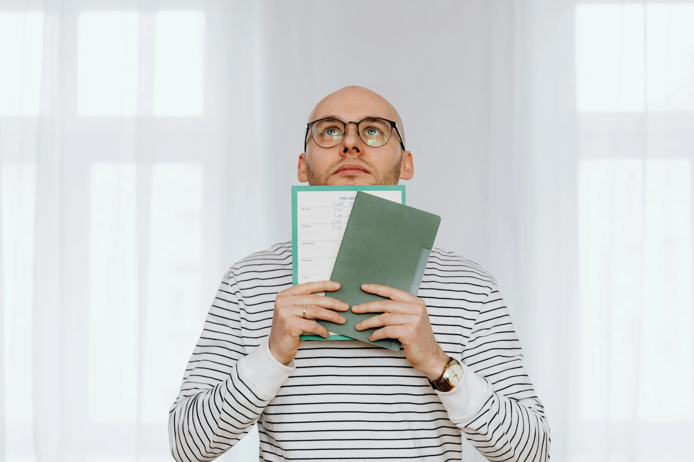 a man is holding two books in front of his face