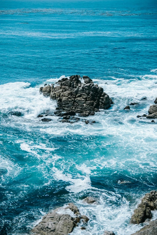 the rocks on the water are surrounded by waves