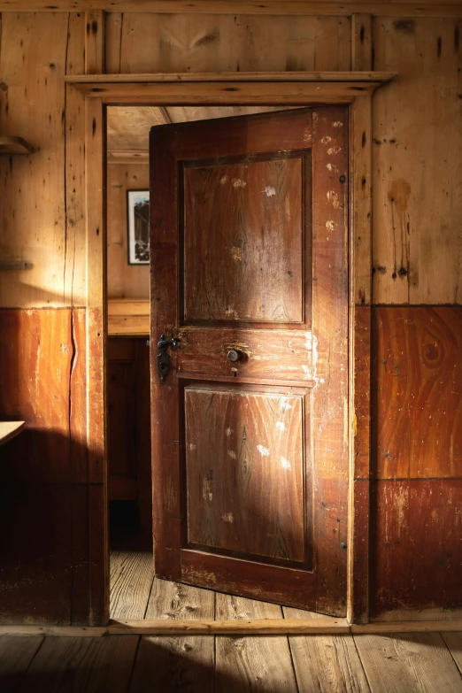an old wooden door with a shelf in the background