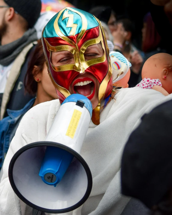 the man is screaming with a megaphone in his hand