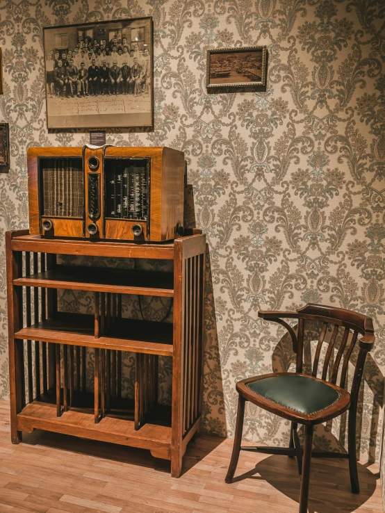 an old wooden cabinet in a room with wallpaper