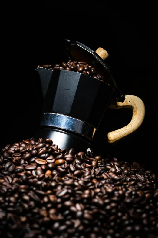 the coffee grinder is next to many coffee beans