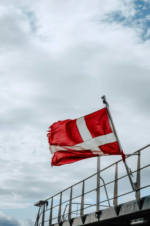 a red and white flag flying on a building