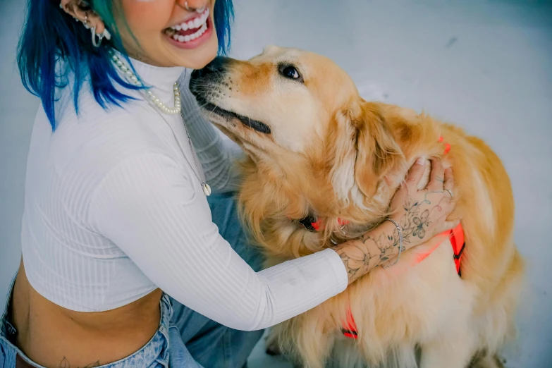 woman smiling and touching her dog outside in snow