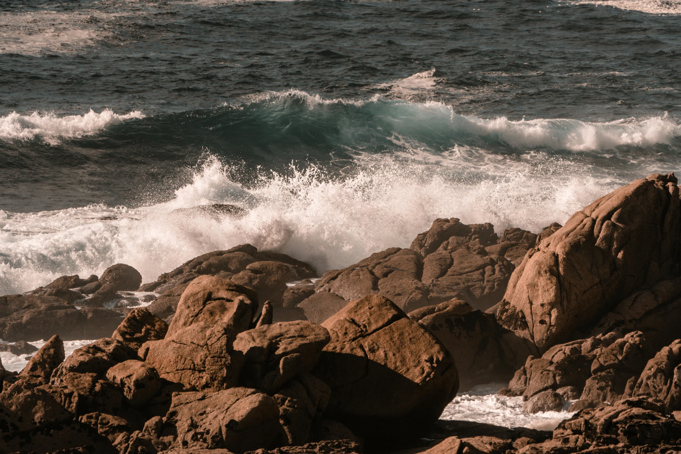 some waves and big rocks in the water