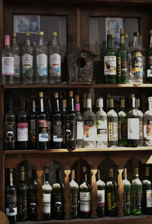 a large collection of liquors are on the shelves