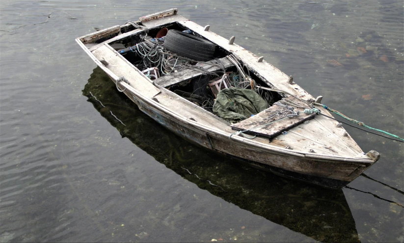 a small wooden boat sits on the water