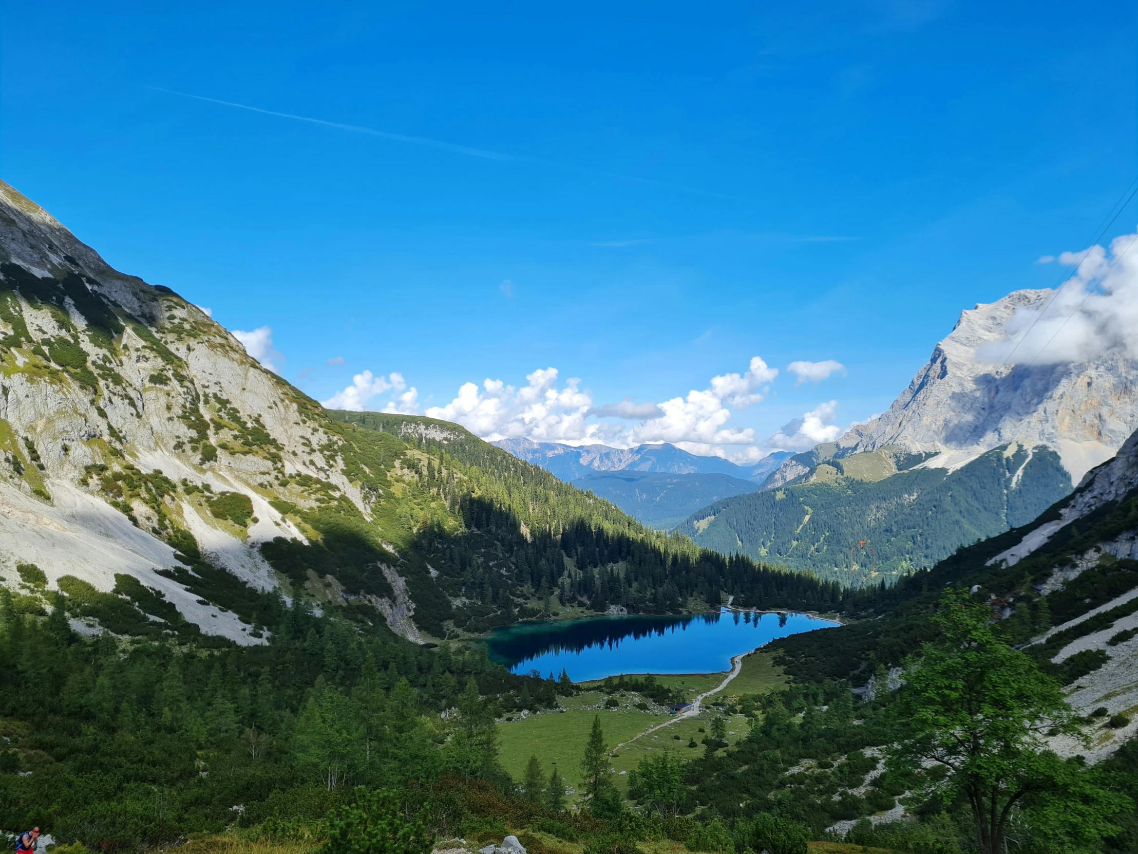 a beautiful view from a high viewpoint of mountains and lake