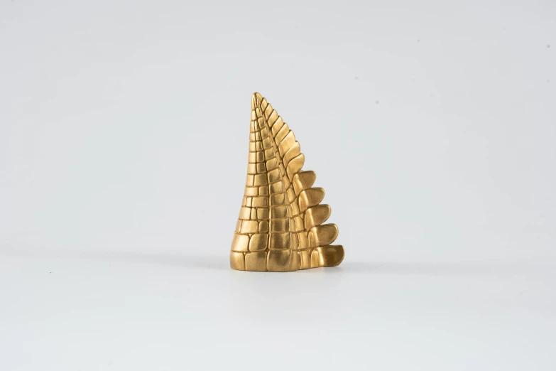 the golden toy is shaped like a pyramid