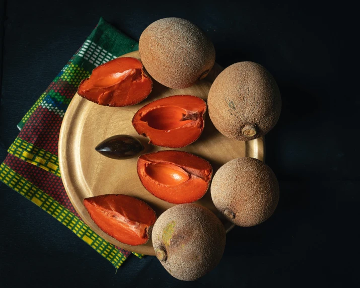 several pieces of fruit, one on top of a knife