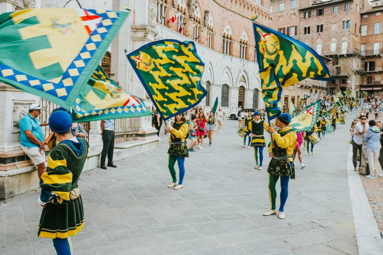 some people holding kites in the street