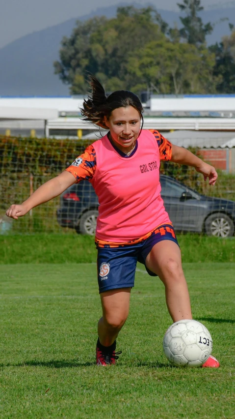 a  kicks a soccer ball while playing