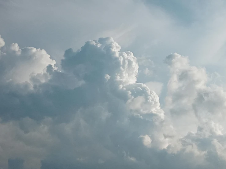 a airplane is seen in the background under a very large cloud